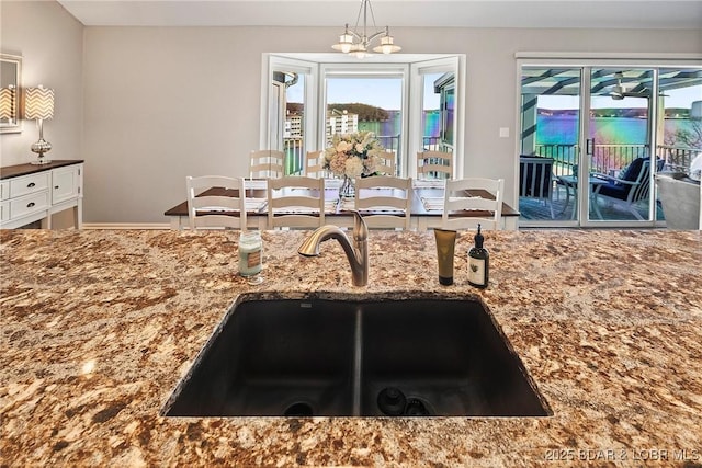 kitchen featuring sink, an inviting chandelier, and decorative light fixtures