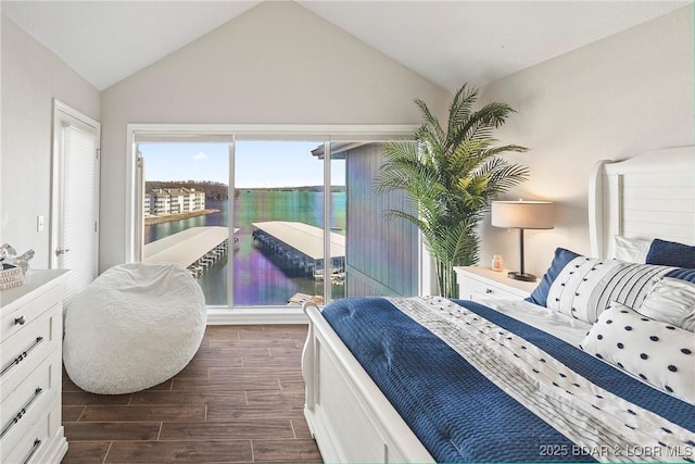 bedroom with a water view and lofted ceiling