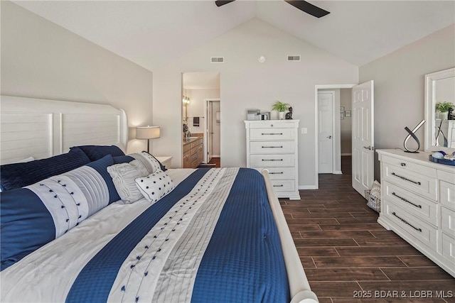 bedroom featuring ceiling fan, lofted ceiling, and ensuite bath