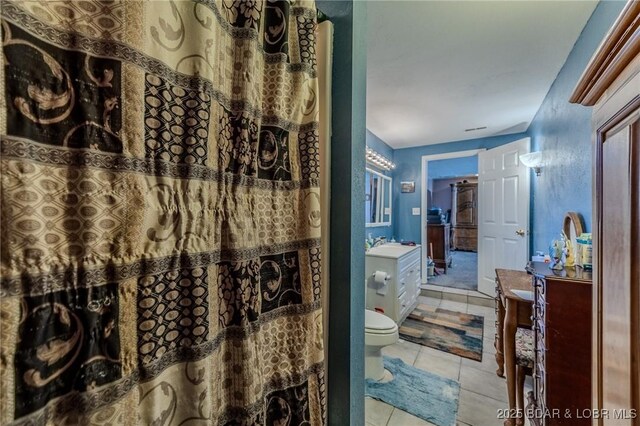 bathroom with vanity, tile patterned floors, and toilet