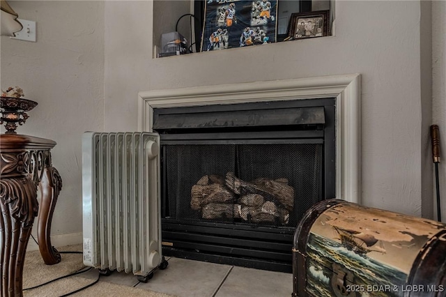 interior details with radiator and a fireplace