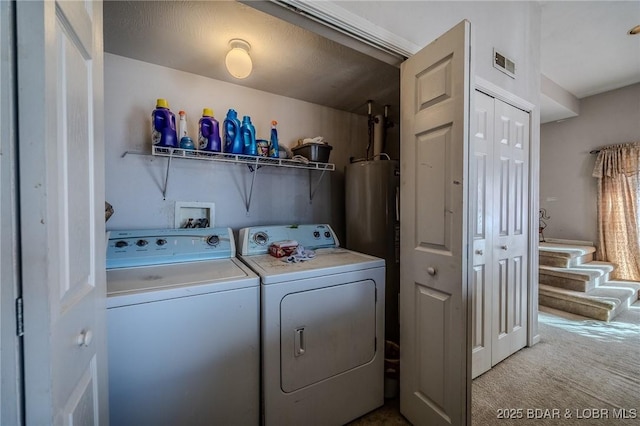 laundry area featuring washer and clothes dryer, visible vents, laundry area, and carpet