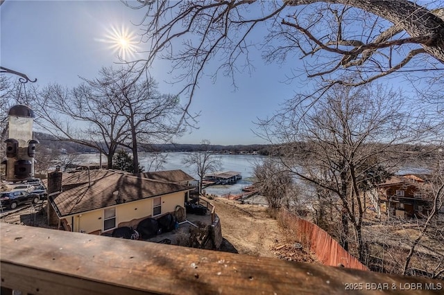 property view of water featuring fence