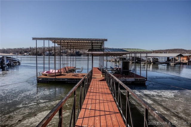 dock area featuring boat lift and a water view