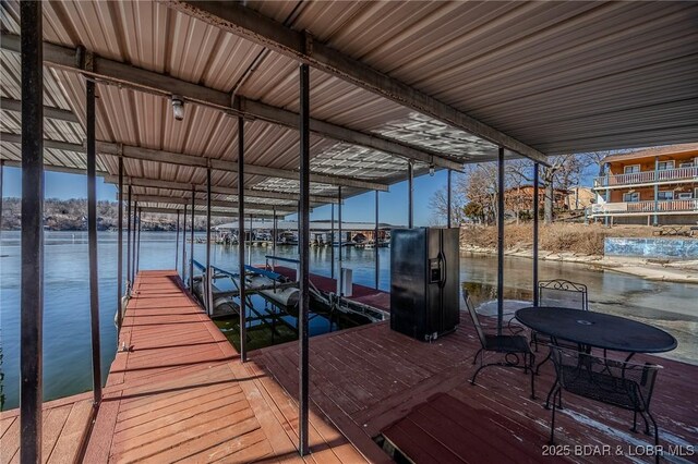 view of dock with boat lift and a water view