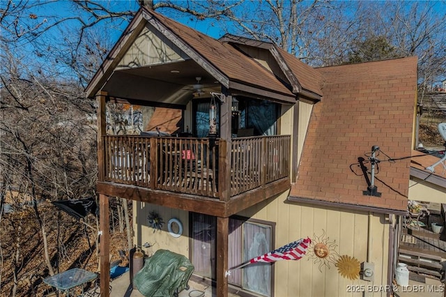 view of home's exterior featuring a shingled roof and a ceiling fan