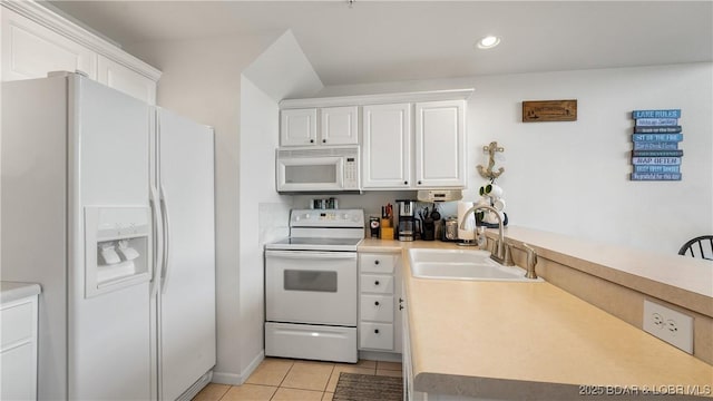 kitchen with white cabinetry, white appliances, sink, and light tile patterned floors