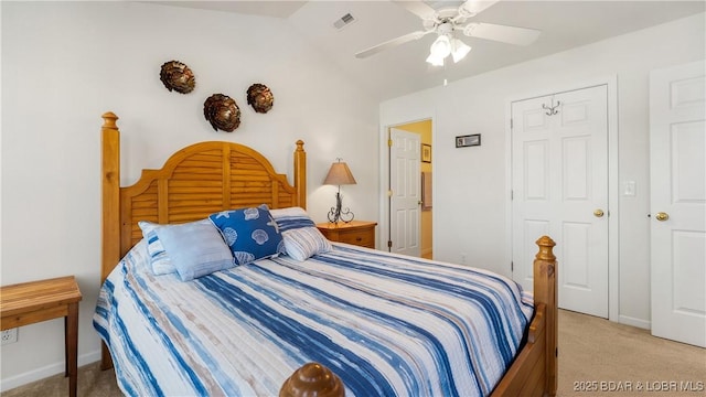 carpeted bedroom featuring ceiling fan and vaulted ceiling