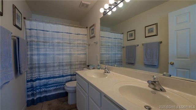 bathroom with tile patterned flooring, vanity, a shower with curtain, and toilet