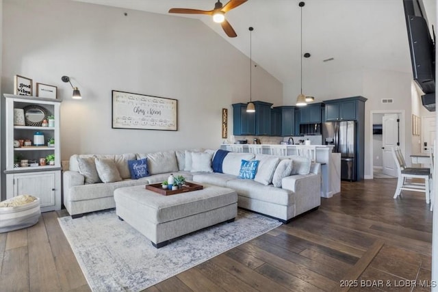 living room featuring ceiling fan, dark wood-type flooring, and high vaulted ceiling