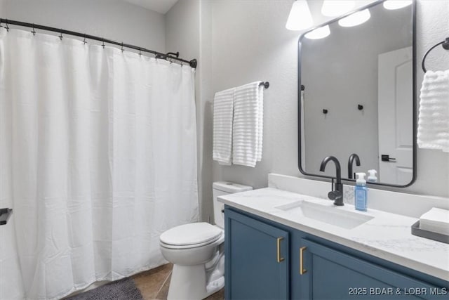 bathroom with vanity, toilet, and tile patterned flooring