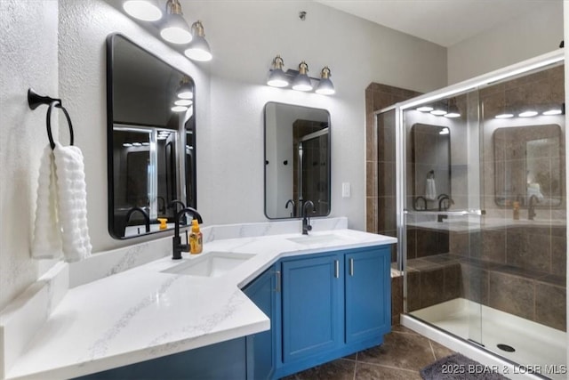 bathroom with tile patterned flooring, vanity, and walk in shower