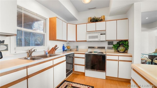 757 Malibu Rd Unit A101, Osage Beach, MO 65065 - kitchen with white microwave, range with electric stovetop, a sink, dishwasher, and light wood-style floors
