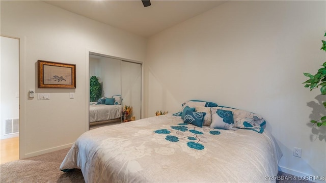 bedroom featuring a closet, ceiling fan, and carpet