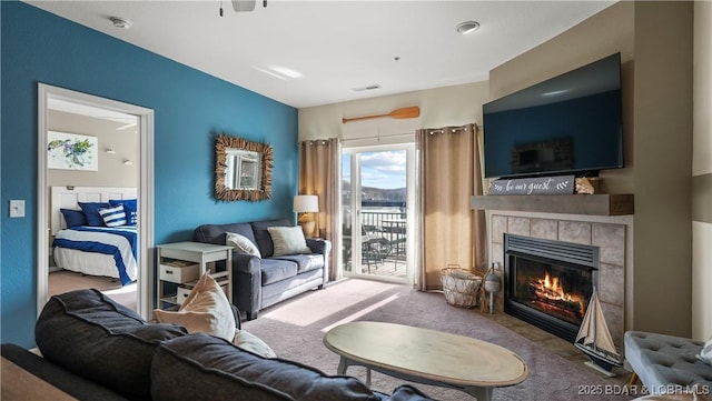 living room featuring light carpet and a fireplace