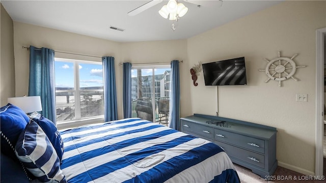 bedroom with ceiling fan and light colored carpet