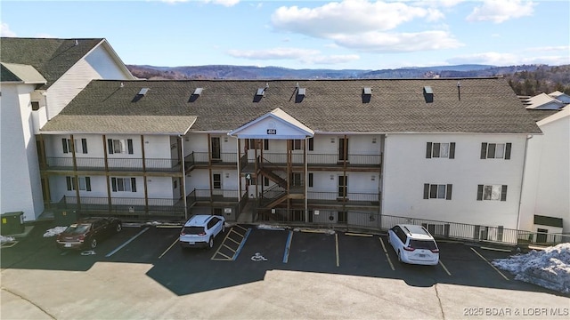 view of building exterior featuring a mountain view and central AC unit