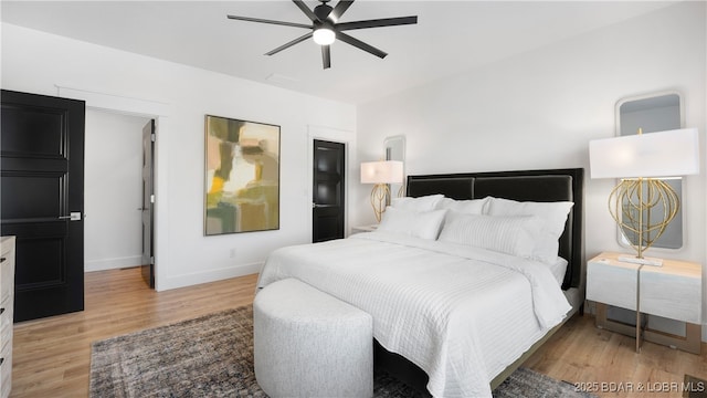 bedroom with ceiling fan and light hardwood / wood-style floors