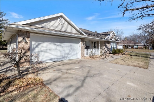 single story home with a garage and covered porch