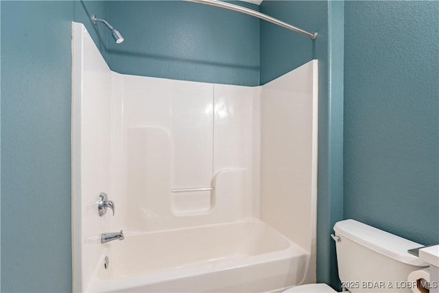 bathroom featuring toilet and bathing tub / shower combination