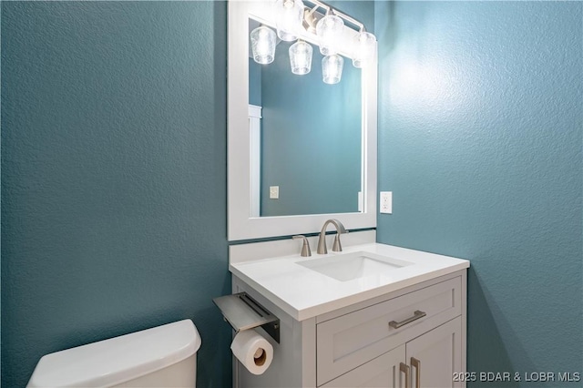 bathroom featuring vanity and toilet