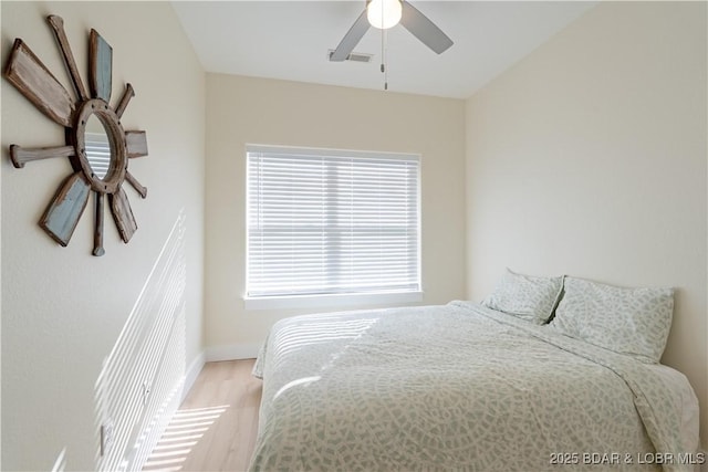 bedroom with visible vents, ceiling fan, and light wood finished floors