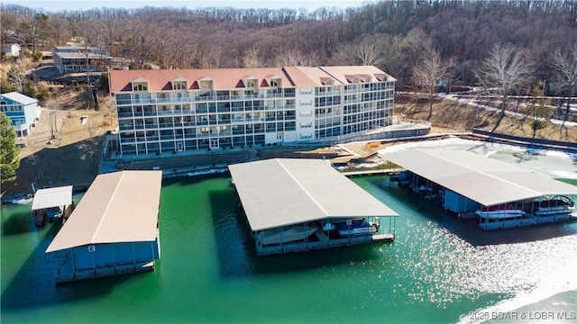 birds eye view of property with a water view and a view of trees