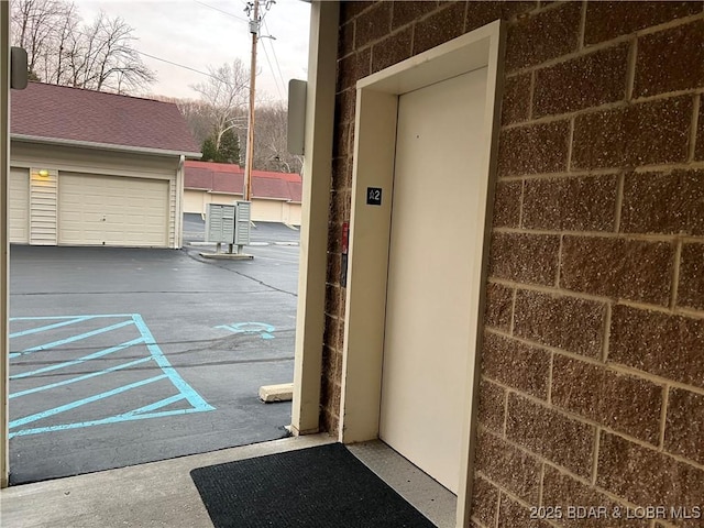 entrance to property with elevator and a garage