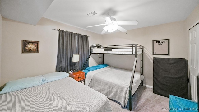 carpeted bedroom featuring ceiling fan and a closet