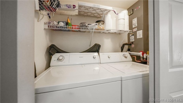 clothes washing area with washer and clothes dryer