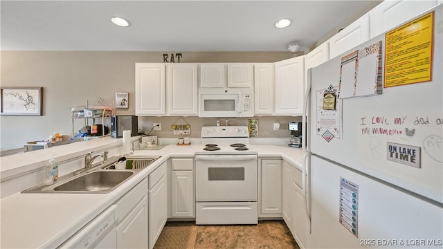 kitchen featuring white appliances, sink, and white cabinets