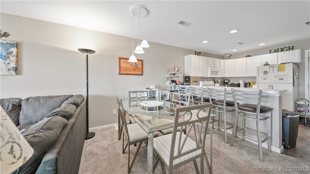 view of carpeted dining space