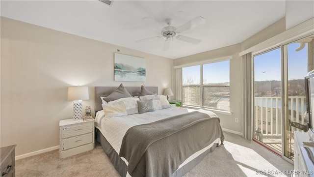 bedroom featuring access to outside, light carpet, and ceiling fan