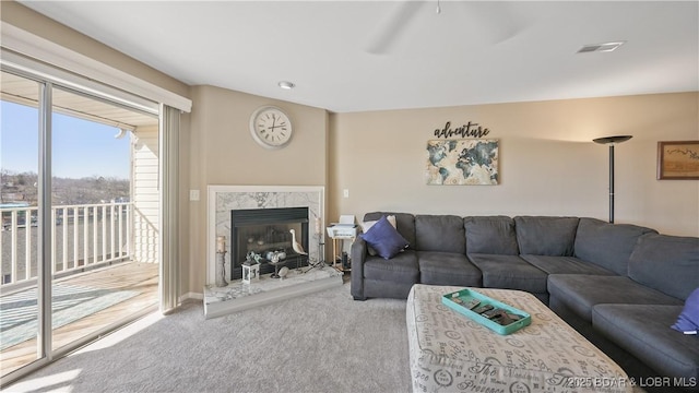 carpeted living room with a high end fireplace