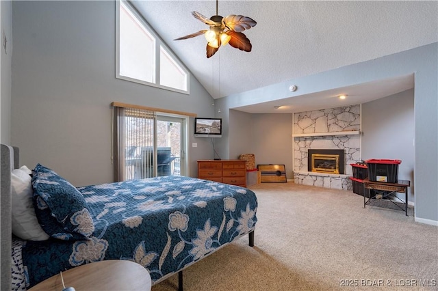 bedroom with a stone fireplace, high vaulted ceiling, a textured ceiling, carpet flooring, and access to exterior