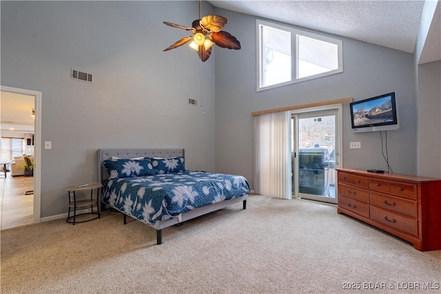 carpeted bedroom with access to exterior, high vaulted ceiling, a textured ceiling, and ceiling fan