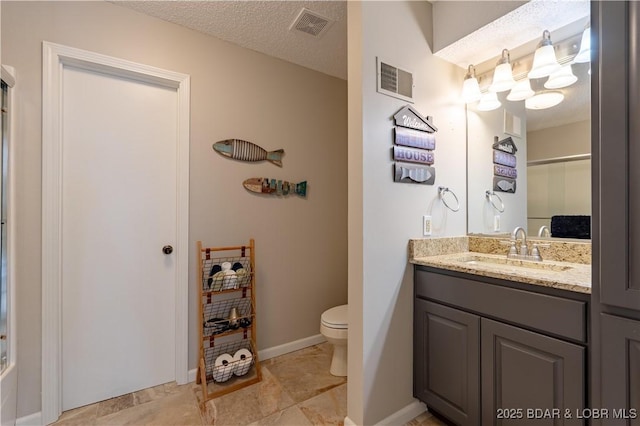 bathroom featuring vanity, walk in shower, a textured ceiling, and toilet