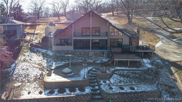 back of property featuring a balcony