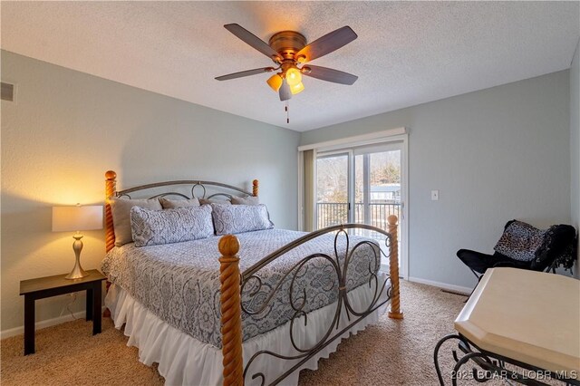 carpeted bedroom with access to exterior, a textured ceiling, and ceiling fan