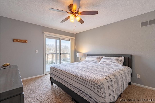 bedroom with carpet floors, access to exterior, and a textured ceiling