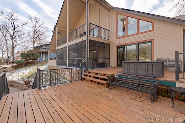 wooden deck featuring a sunroom and an outdoor hangout area