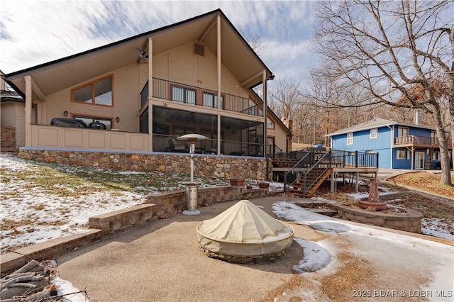 view of snow covered rear of property