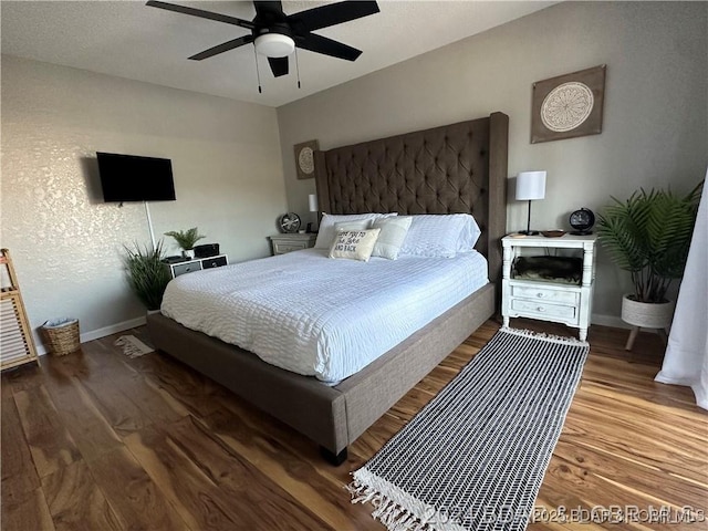 bedroom with ceiling fan and hardwood / wood-style floors