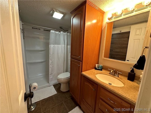 bathroom with vanity, a shower with shower curtain, and a textured ceiling