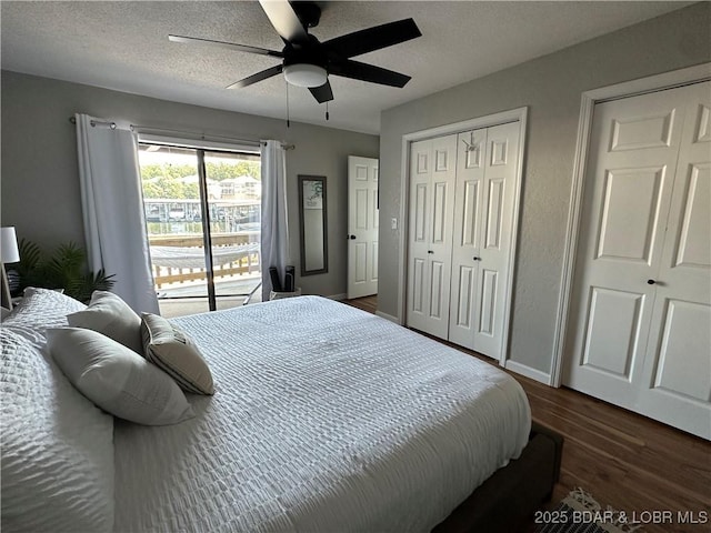 bedroom featuring ceiling fan, dark hardwood / wood-style floors, and a textured ceiling