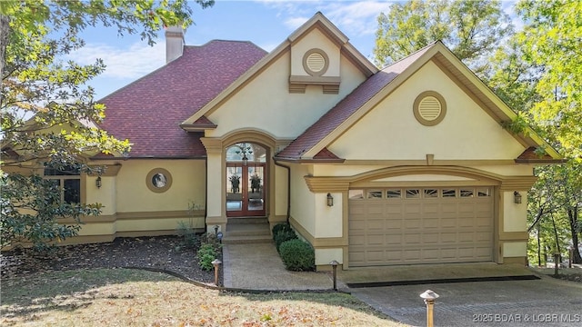 view of front of home with french doors and a garage