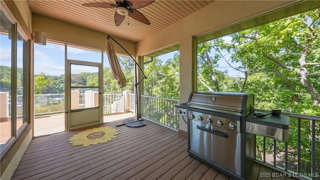 unfurnished sunroom featuring ceiling fan and a wealth of natural light