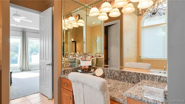 bathroom featuring tile patterned flooring, vanity, and ceiling fan