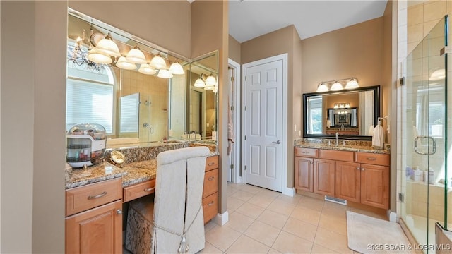 bathroom featuring an enclosed shower, vanity, and tile patterned floors