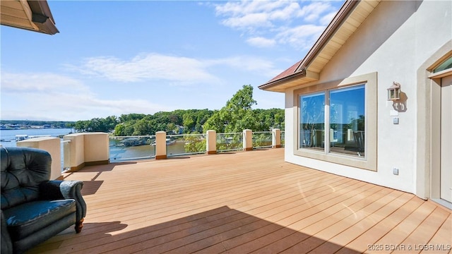 wooden terrace featuring a water view